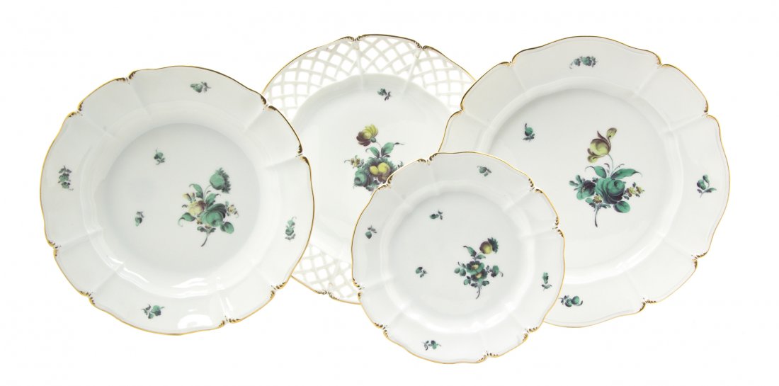 A Nymphenburg Porcelain Partial Dinner Service, Di: A Nymphenburg Porcelain Partial Dinner Service, comprising 10 dinner plates, 12 bread plates, 11 dinner plates with lattice edges and 11 salad plates, each having green floral decoration on an ivory r
