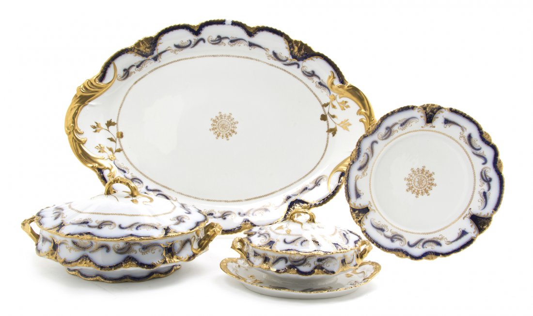A Set of Twelve Theodore Haviland Limoges Porcelai: A Set of Twelve Theodore Haviland Limoges Porcelain Plates, with a serving platter, a sauce tureen and a covered entree, each with gilt and cobalt decoration. Diameter 9 3/4 inches. Property from the 