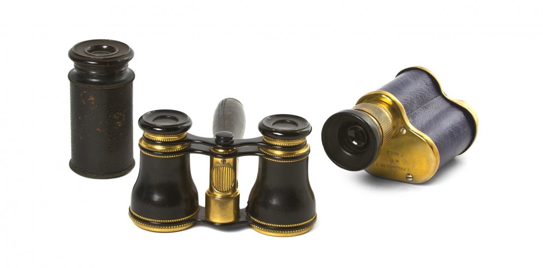 A Pair of French Leather Veneered Opera Glasses,: A Pair of French Leather Veneered Opera Glasses, having a central handle with a focus wheel, together with two monoculars. Width of first 3 7/8 inches. Property from the Estate of Mr. Mark Fritz, West