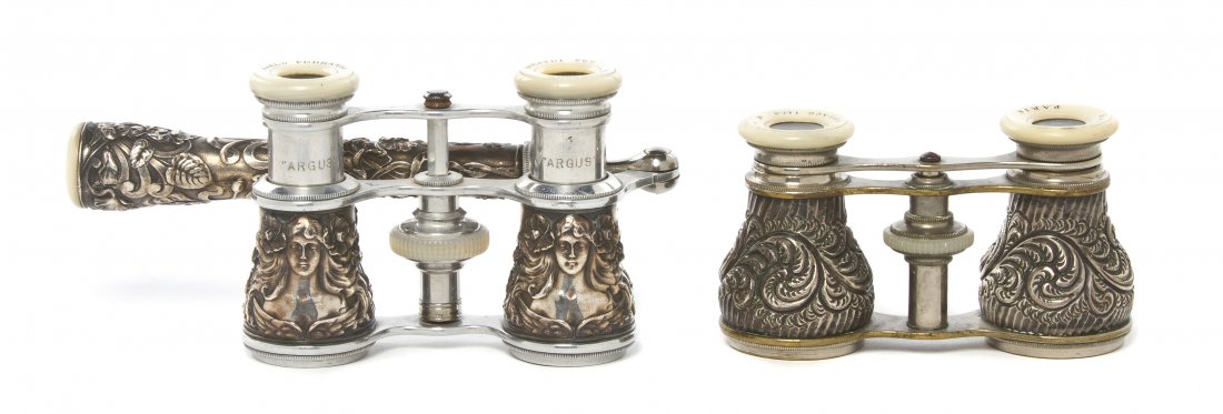 Two Pairs of Continental Silver or Silvered Metal: Two Pairs of Continental Silver or Silvered Metal Cased Opera Glasses, the first Pablo Perrando, decorated with Art Nouveau ladies in relief with handle, the second L'Amour, Paris, retailed by C.D. Pe