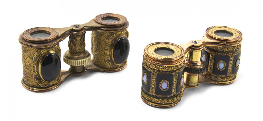 Two Pairs of French Stone Inset Opera Glasses, Wi: Two Pairs of French Stone Inset Opera Glasses, the first with black oval stones set on gilt metal cylinders, the second with a series of rectangular insets on gilt metal cylinders. Width of widest 3 7