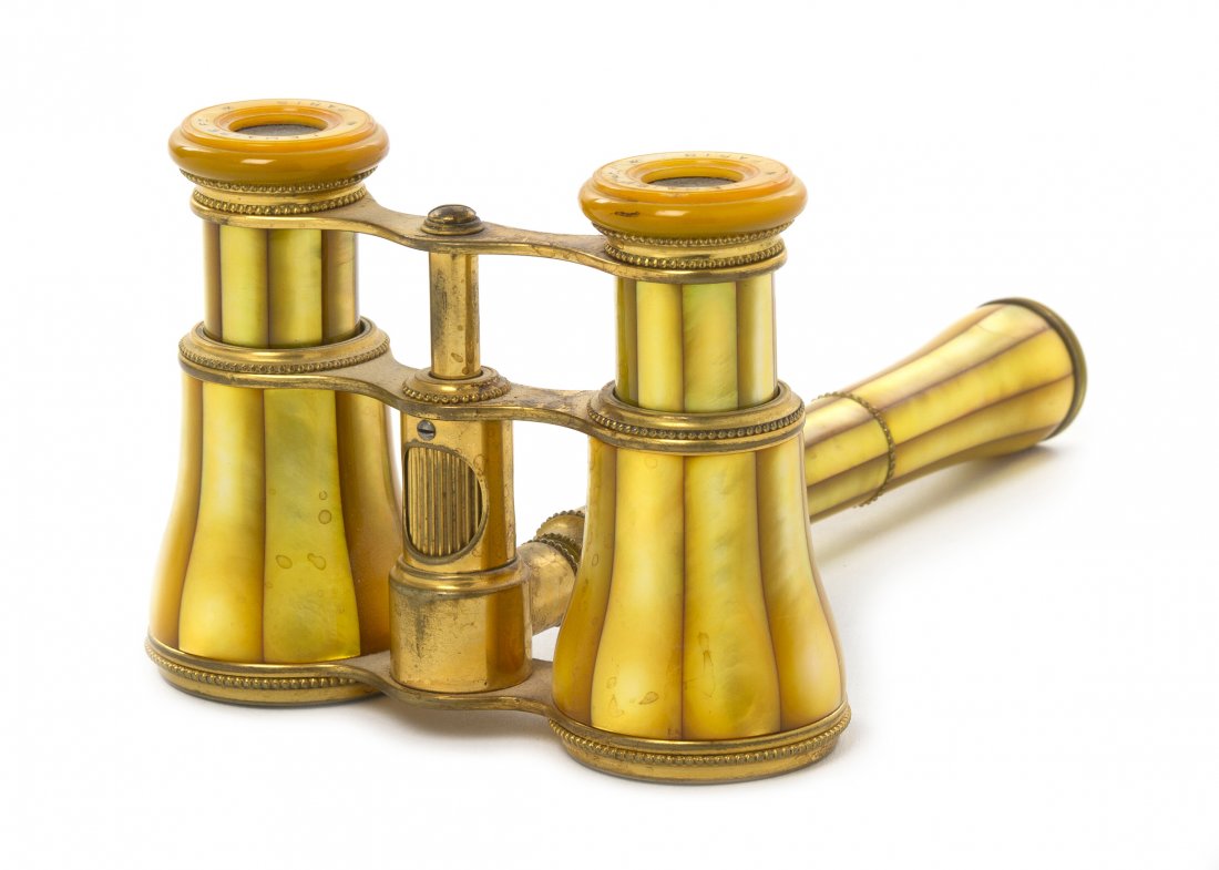 A Pair of French Mother-of-Pearl Veneered Opera G: A Pair of French Mother-of-Pearl Veneered Opera Glasses, Lemaire, with an adjuster in the handle, yellow toned. Width 3 7/8 inches. Property from the Estate of Mr. Mark Fritz, West Bloomfield, Michiga