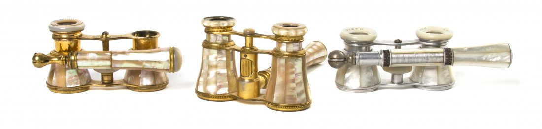 Three Pairs of French Mother-of-Pearl Veneered Op: Three Pairs of French Mother-of-Pearl Veneered Opera Glasses, comprising an example by La Reine and two others, two with swing handles, the third with a central handle having a focus wheel. Width 3 7/