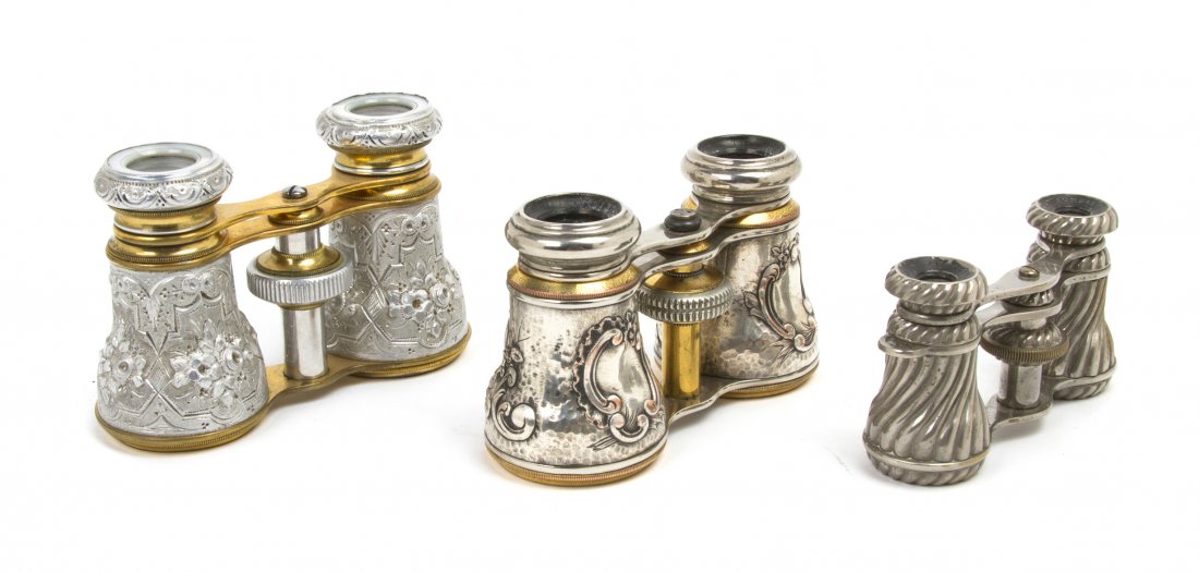 Three Pairs of Continental Silver or Silvered Met: Three Pairs of Continental Silver or Silvered Metal Mounted Opera Glasses, two with repousse foliate decoration, the third twist decoration. Width of widest 4 1/4 inches. Property from the Estate of M