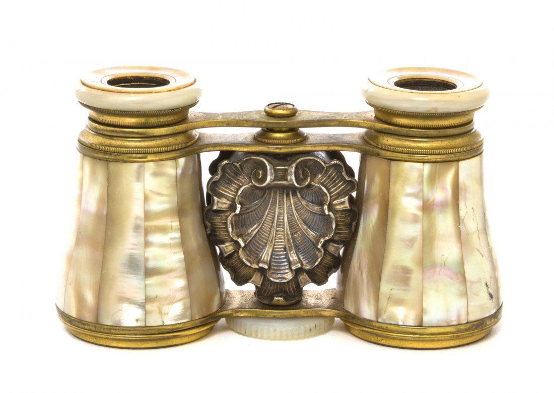 A Pair of Mother-of-Pearl Veneered and Silver Set: A Pair of Mother-of-Pearl Veneered and Silver Set Opera Glasses, the center set with shell form decoration. Width 3 7/8 inches. Property from the Estate of Mr. Mark Fritz, West Bloomfield, Michigan