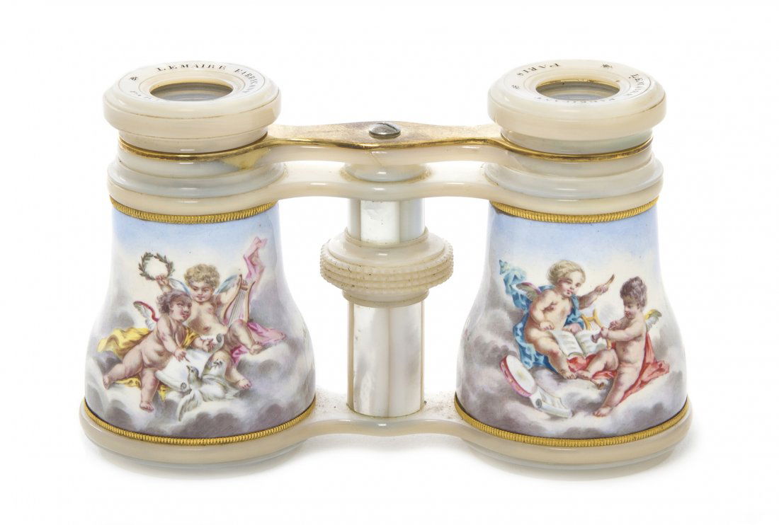 A Pair of French Enameled and Mother-of-Pearl Ven: A Pair of French Enameled and Mother-of-Pearl Veneered Opera Glasses, Lemaire, decorated with putti in clouds, with gilt metal banding. Width 4 1/8 inches. Property from the Estate of Mr. Mark Fritz,