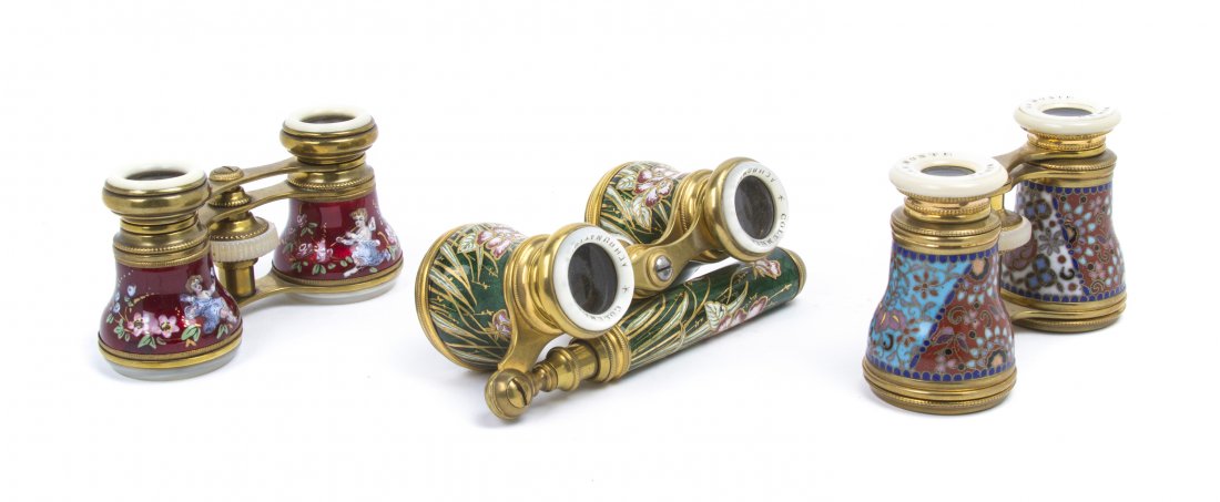 Three Pairs of Continental Enameled Opera Glasses: Three Pairs of Continental Enameled Opera Glasses, the first with champleve decoration by Lamonte, the second with floral decoration on a green reserve with handle, the third with figural decoration o