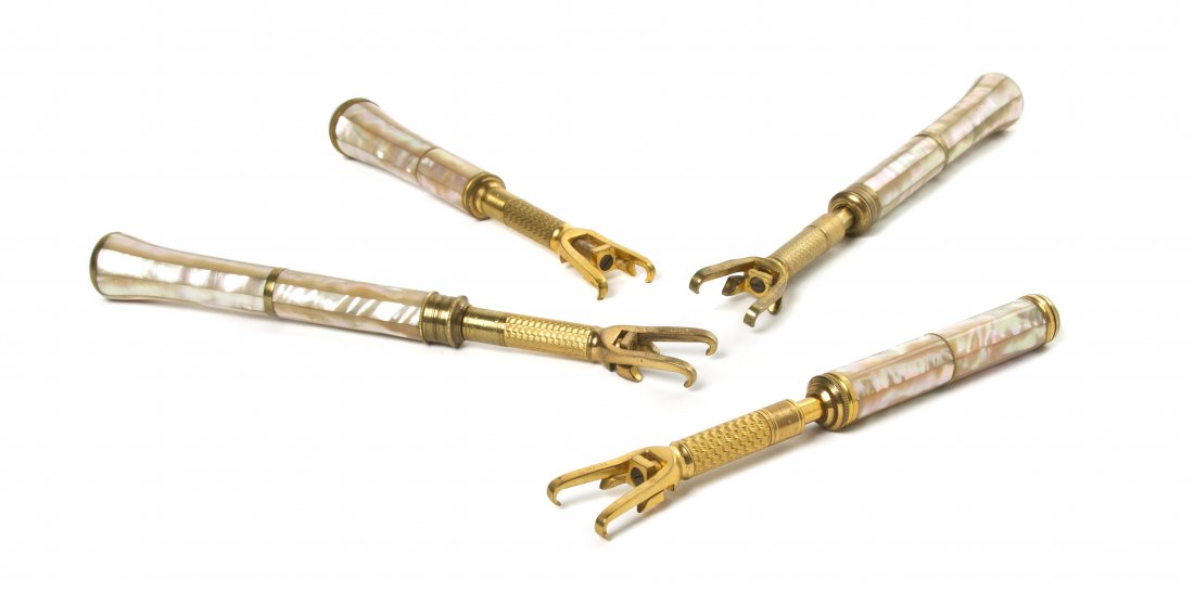 Four French Mother-of-Pearl Veneered Opera Glass: Four French Mother-of-Pearl Veneered Opera Glass Holders, each with faceted handles and engine turned shafts. Length of longest 7 5/8 inches (closed). Property from the Estate of Mr. Mark Fritz, West