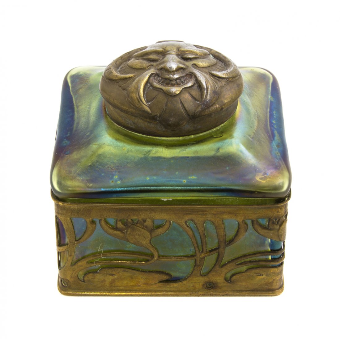 An Austrian Glass and Gilt Metal Inkwell, Attribu: An Austrian Glass and Gilt Metal Inkwell, Attributed to Loetz, having a circular lid decorated with a satyr mask over the square body with repeating stylized lotus decoration. Width 3 1/4 inches. Prop