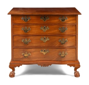 A Chippendale Carved And Figured Mahogany Serpentine Chest Of Drawers