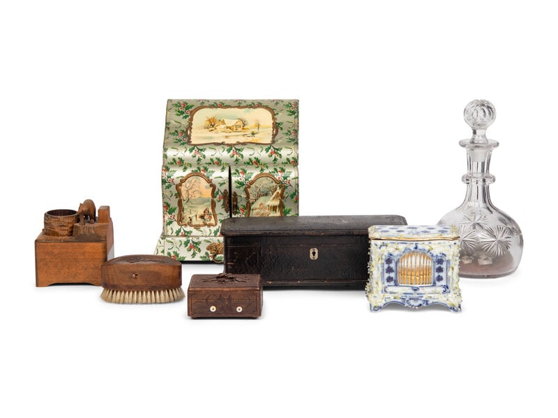 A Group of Musical Novelties : A Group of Musical Novelties comprising a decanter, a celluloid dressing case, a leather glove box with label from Conchon, a German porcelain organ form trinket box, and three black forest