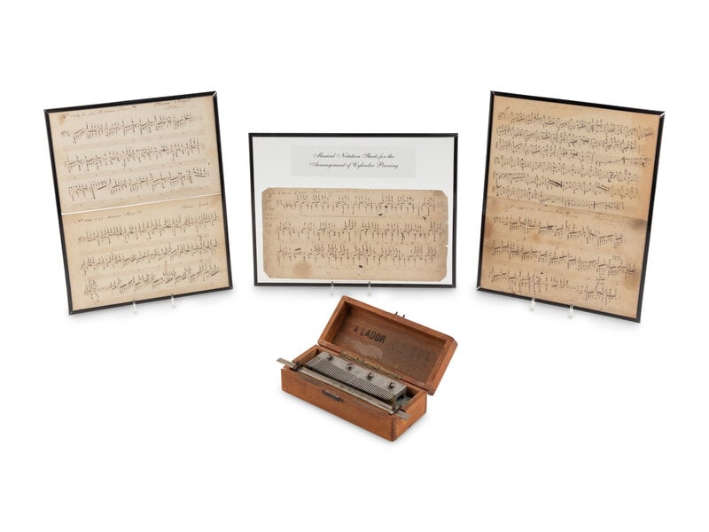 A Music Box Tuning Comb and Musical Notation Sheets for the Arrangement of Cylinder Pinning: A Music Box Tuning Comb and Musical Notation Sheets for the Arrangement of Cylinder Pinning with 6 inch cylinder, sliding scale, in hinged wood case, marked A. Lador #207; includes five doub