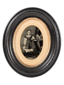 [EARLY PHOTOGRAPHY]. Tintype portrait of a little girl posed with stereoviews, viewer, and photo