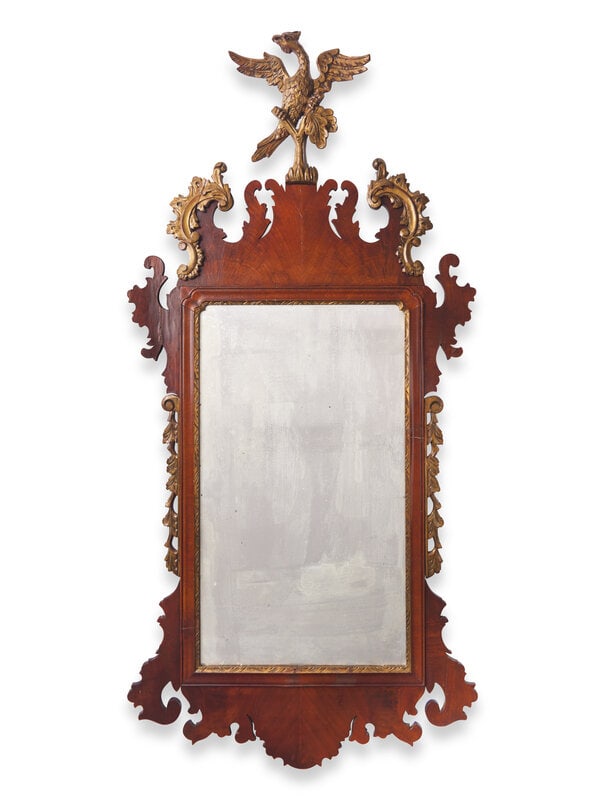 A Chippendale Style Parcel-Gilt And Mahogany Veneered Looking Glass: A Chippendale Style Parcel-Gilt And Mahogany Veneered Looking Glass Friedman Brothers, 20th Century 55 x 26 1/2 inches. This lot is located in Philadelphia.