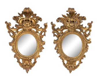 A Pair of Italian Baroque Oval Giltwood Mirrors