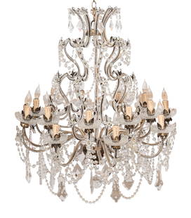 A Gilt Bronze and Cut Glass Eighteen-Light Chandelier: A Gilt Bronze and Cut Glass Eighteen-Light Chandelier In the manner of Maison Baguès, late 19th century Each tier festooned with crystal swags, prisms, and flowers. Height 40 inches x diameter ap