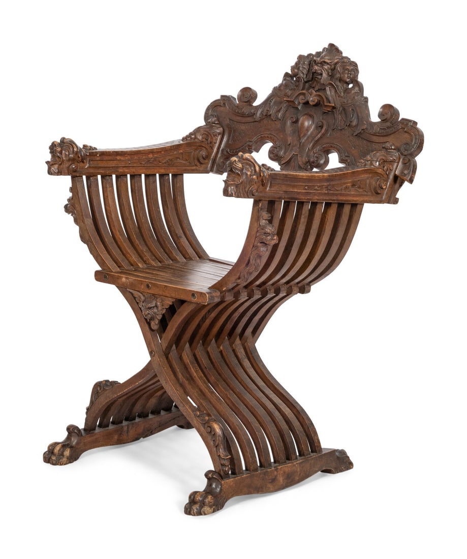 An Italian Renaissance Revival Carved Walnut Savonarola Chair: An Italian Renaissance Revival Carved Walnut Savonarola Chair 19th Century Carved with allegorical motifs, the arms terminating in roaring creatures and raised on paw feet. Height 40 3/4 x width 29 1/