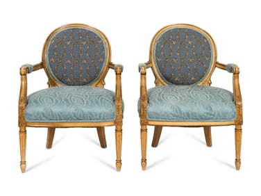 A Pair of Louis XVI Style Cream-Painted and Parcel Gilt Fauteuils with Needlepoint Backs