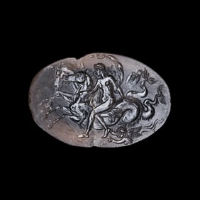 A Roman Smokey Quartz Intaglio with a Nereid Riding Two Hippocamps