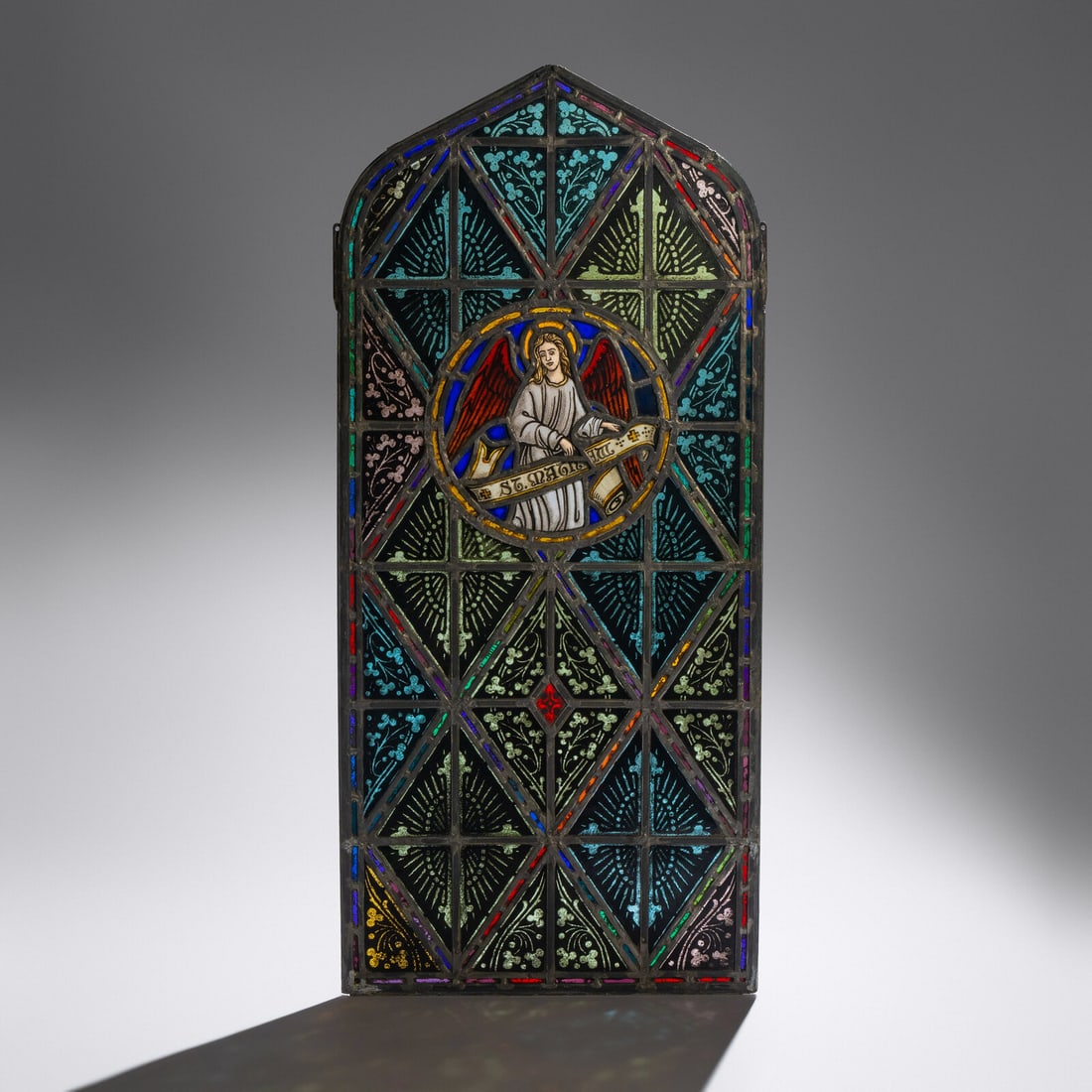 Linden Glass Company (Chicago, 1884–1934) Window with Gothic-arch and painted St. Matthew (1 of 2)