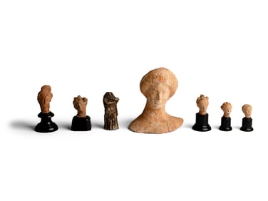 Six Greek Terracotta Heads and One Headless Figure