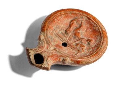 A Roman Terracotta Lamp with Symplegma Scene