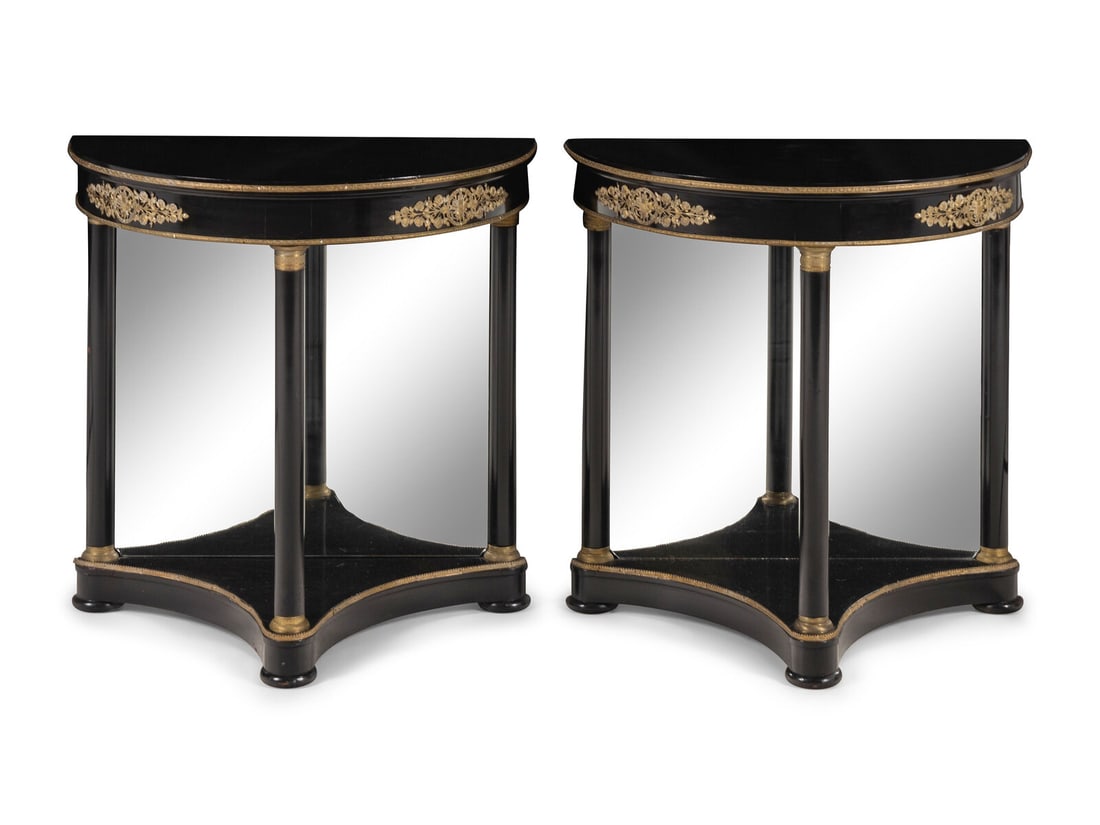 A Pair of Empire Style Gilt Bronze Mounted and Black Lacquered Demi Lune Console Tables: A Pair of Empire Style Gilt Bronze Mounted and Black Lacquered Demi Lune Console Tables Maison Jansen, 20th Century Height 30 1/2 x width 30 1/8 x depth 15 inches. This lot is located in Chicago.