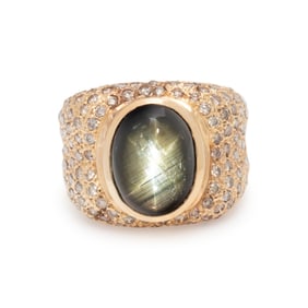 BLACK STAR SAPPHIRE, DIAMOND, AND YELLOW GOLD RING