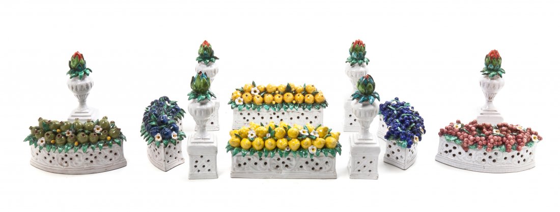 An Italian Ceramic Table Garniture, Height of tallest 7: An Italian Ceramic Table Garniture, in 12 parts, having 6 flowering urns and 6 floral laden segments. Height of tallest 7 5/8 inches. Property from the Collection of Dr. and Mrs. Sumner Barenberg, Chi