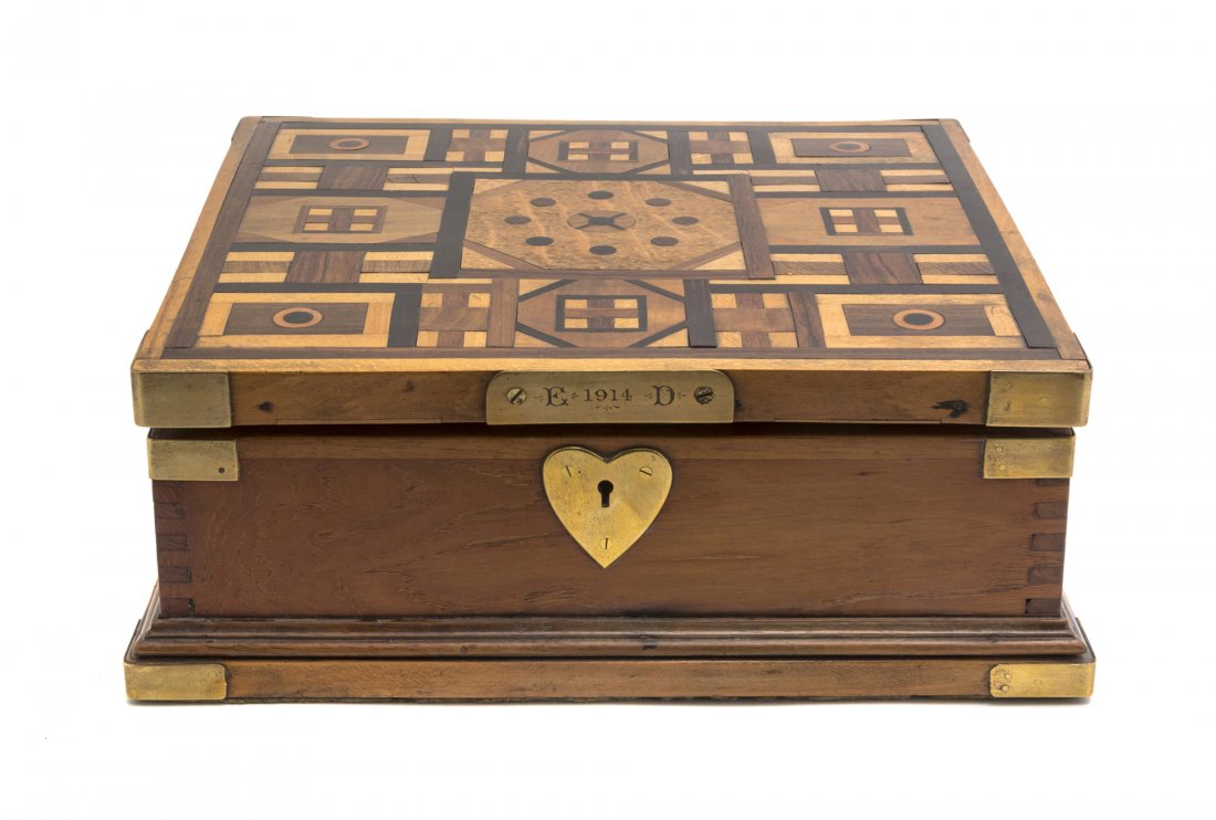 A Parquetry Humidor, Width 12 1/2 inches.: A Parquetry Humidor, the square top having various geometric inlays above the brass heart shape escutcheon inscribed E.D. 1914, opening to a segmented interior. Width 12 1/2 inches. Property from the 
