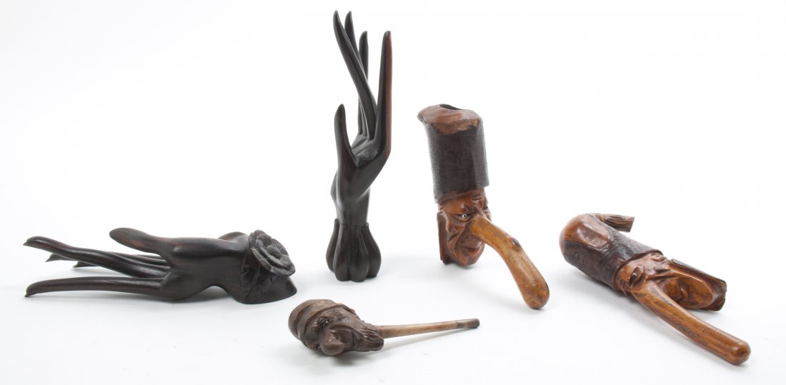 A Collection of Carved Wood Articles, Length of longest: A Collection of Carved Wood Articles, comprising three pipes and two Balinese hands. Length of longest 8 1/2 inches. Property from the Estate of Mr. Mark Fritz, West Bloomfield, Michigan