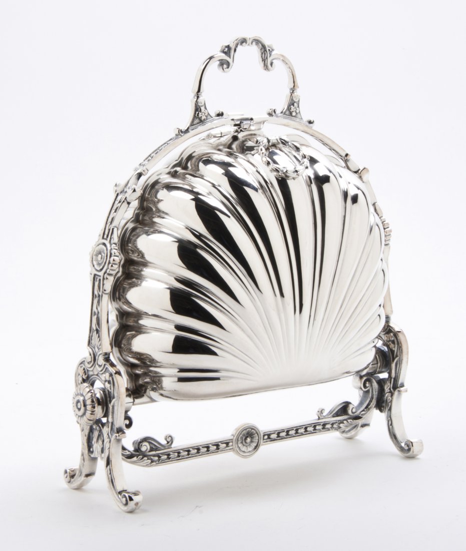 An English Silverplate Warming Stand, Height 10 1/2 inc: An English Silverplate Warming Stand, having two shell form hinged segments with liners. Height 10 1/2 inches. Property from the Collection of Dr. and Mrs. Sumner Barenberg, Chicago, Illinois