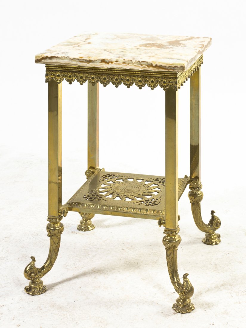 A Victorian Brass and Onyx Pedestal Table, Height 19 1/: A Victorian Brass and Onyx Pedestal Table, having a square top raised on conforming legs, joined by a sun centered medial shelf, raised on cornucopia form feet. Height 19 1/4 inches.