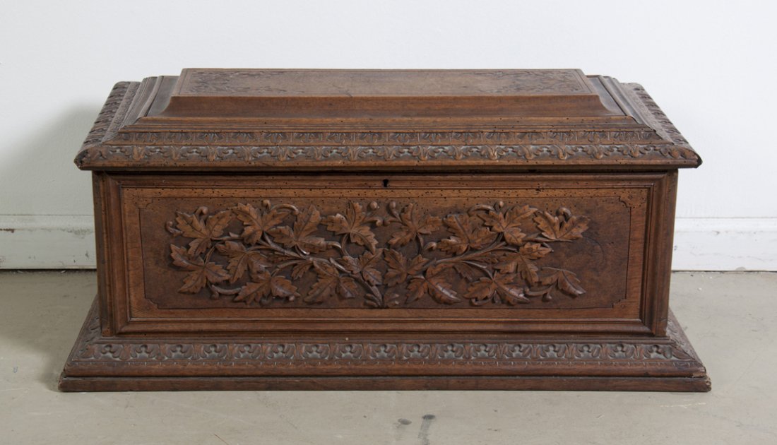 A Victorian Carved Walnut Chest, Width 29 3/4 inches.: A Victorian Carved Walnut Chest, having a rectangular hinged lid over the conforming case with leaf decoration throughout. Width 29 3/4 inches. Property from the Estate of Mr. Mark Fritz, West Bloomfi