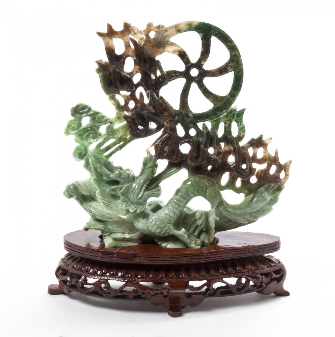 A Chinese Carved Hardstone Figure, Height 6 1/4 inches.: A Chinese Carved Hardstone Figure, depicting a dragon with a flaming Buddhist wheel and lingzhi form clouds, raised on a pierce carved wood base. Height 6 1/4 inches. Property from the Collection of D