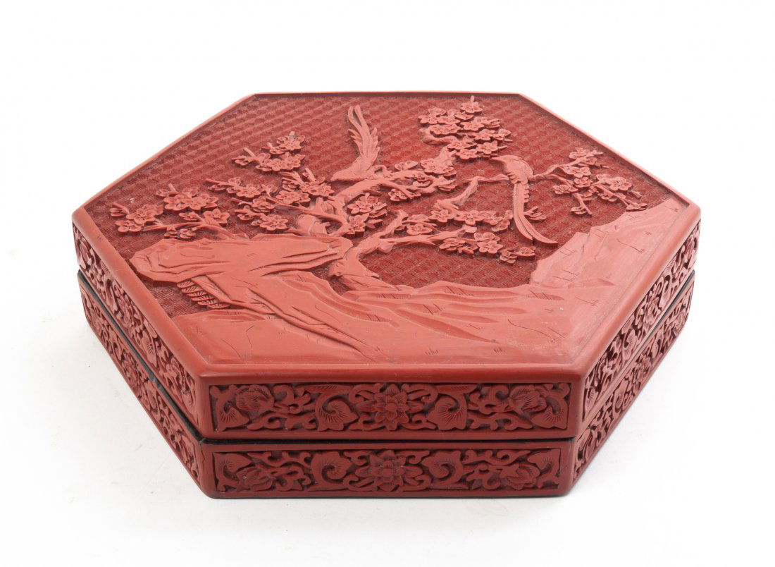 A Cinnabar Lacquer Hexagonal Box, Width at widest 12 in: A Cinnabar Lacquer Hexagonal Box, depicting exotic birds amongst a cherry blossom tree. Width at widest 12 inches.