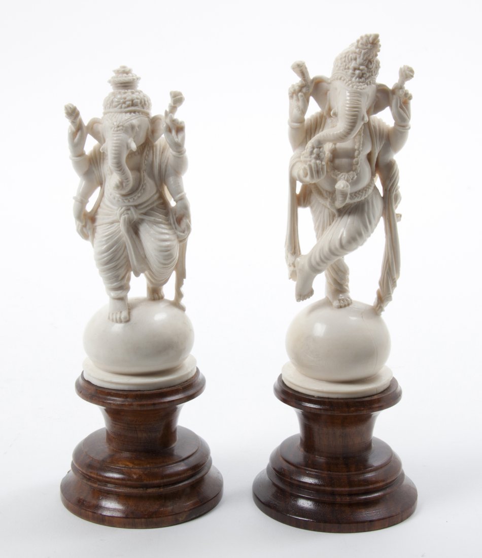 A Pair of Indian Carved Ivory Figures of Ganesha, Heigh: A Pair of Indian Carved Ivory Figures of Ganesha, the deity depicted standing on a dome, each raised on a turned wood pedestal base. Height of tallest 6 3/4 inches. Property from the Collection of Mr.
