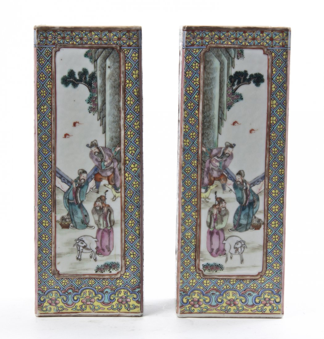 A Pair of Famille Rose Cong Form Porcelain Vases, Heigh: A Pair of Famille Rose Cong Form Porcelain Vases, each having a floral boarder surrounding a central cartouche depicting mirrored images of figures in a court yard. Height 11 inches.