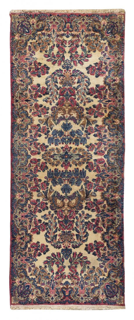 A Kirman Wool Runner, 6 feet 6 inches x 2 feet 6 inches: A Kirman Wool Runner, having allover scrolling foliate decoration on a cream ground. 6 feet 6 inches x 2 feet 6 inches.