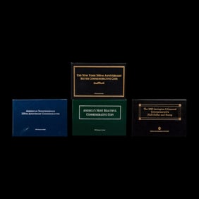 A Group of Four Commemorative 50c Coin and Stamp Sets