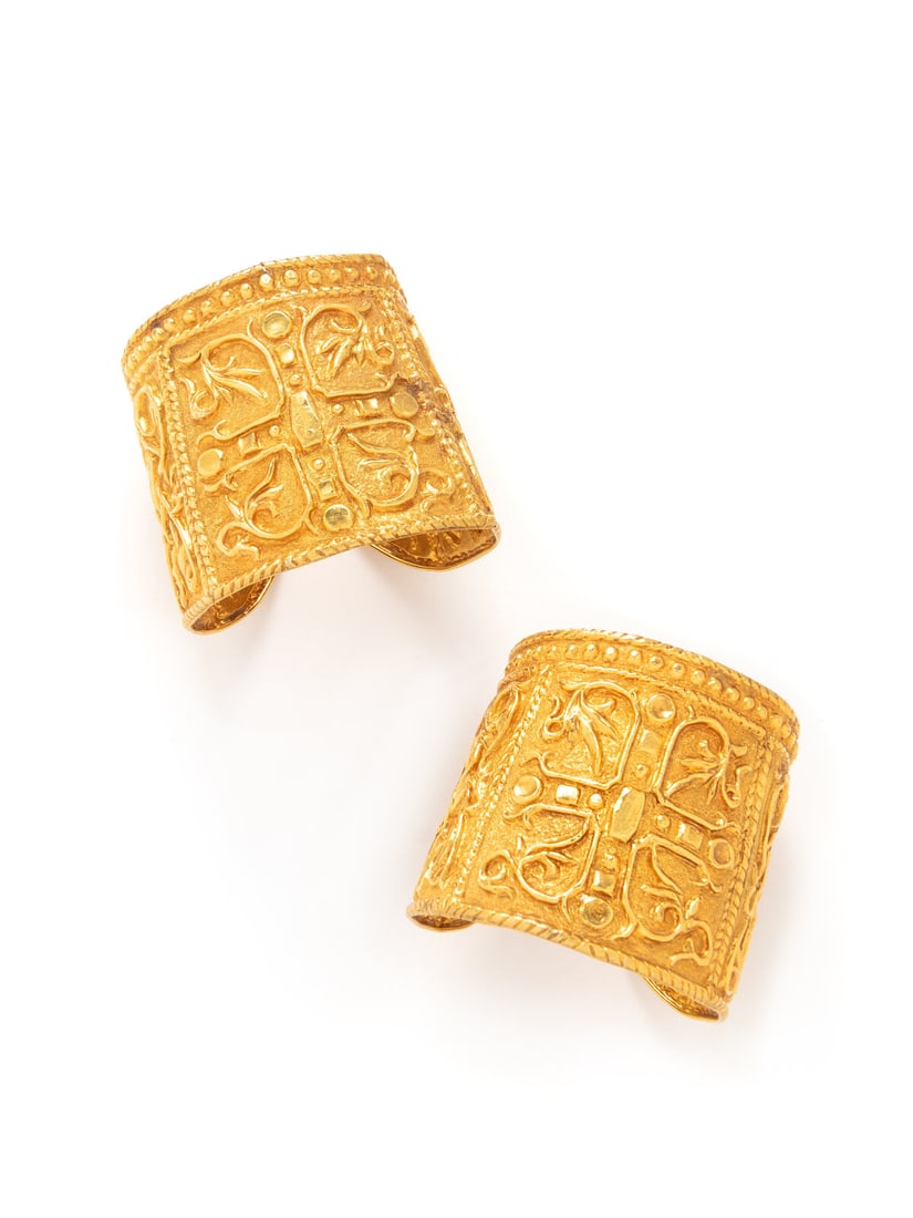 LALAOUNIS, PAIR OF HIGH KARAT GOLD CUFF BRACELETS: LALAOUNIS, PAIR OF HIGH KARAT GOLD CUFF BRACELETS High relief repoussé design with textured finish. 22 karat yellow gold. 6 3/4 inches inner circumference, 2 1/2 inches wide. Stamp: K22 LALAOUNIS