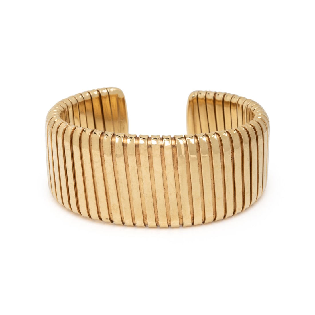 CHIMENTO, YELLOW GOLD TUBOGAS CUFF BRACELET: CHIMENTO, YELLOW GOLD TUBOGAS CUFF BRACELET The wide tapering tubogas flexible cuff measuring approximately 20.00 - 30.00 mm. 18 karat yellow gold. 6 1/4 inches inner circumference. Stamp: A. CHIMENTO