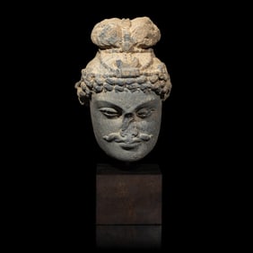 A Gandharan Grey Schist Head of a Bodhisattva, 2nd/3rd Century