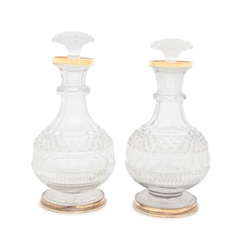 A Near Pair of George III Silver-Gilt Mounted Cut Glass Decanters