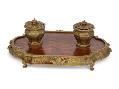 A Gilt Bronze and Parquetry Inlaid Inkwell: A Gilt Bronze and Parquetry Inlaid Inkwell 19th Century with one glass insert. Height 5 x width 14 x depth 9 inches. This lot is located in Chicago.