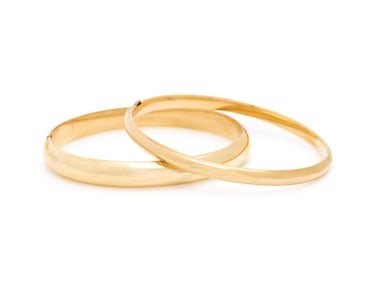 TWO YELLOW GOLD BANGLE BRACELETS