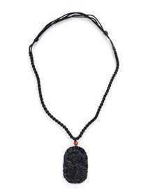 CARVED BLACK JADE PENDANT