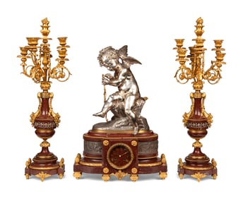 A French Gilt and Silvered Bronze and Rouge Marble Three-Piece Clock Garniture