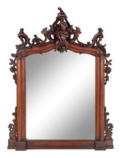 An Italian Rococo Revival Carved Walnut Mirror: An Italian Rococo Revival Carved Walnut Mirror 20th Century Height 69 x width 56 inches. This lot is located in Chicago.