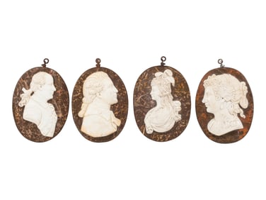 A Set of Four Italian Carved Marble and Iron Mounted Profile Medallions